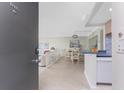 Open-concept living space featuring neutral decor with a dining area and views into the living room at 2955 N Beach Rd # D113, Englewood, FL 34223