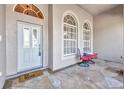 Inviting porch with decorative stone flooring and comfortable seating at 3511 Bay Ridge Way, Port Charlotte, FL 33953