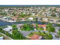 Aerial view of a residential neighborhood with canals and waterfront properties, showcasing a serene community setting at 44 Waterford Dr, Englewood, FL 34223