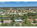 Scenic aerial view of a waterfront home nestled in a lush community with golf course and canals at 4624 Pompano St, Placida, FL 33946