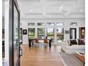 Bright, open-concept living and dining area with hardwood floors and abundant natural light at 4624 Pompano St, Placida, FL 33946