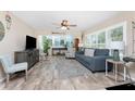 Spacious living room with new plank flooring, neutral paint colors, and bright, natural light at 5055 N Beach Rd # 208, Englewood, FL 34223