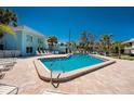 Relaxing pool area with lounge chairs and tables and neatly kept landscaping at 5055 N Beach Rd # 208, Englewood, FL 34223