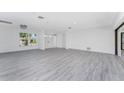 Bright and airy living room featuring stylish gray wood floors and neutral walls at 5232 Conner Ter, Port Charlotte, FL 33981