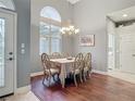 Bright dining room with hardwood floors, chandelier, and large window providing natural light at 5433 White Ibis Dr, North Port, FL 34287