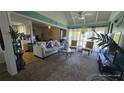 Bright living room with vaulted ceilings, comfortable seating, and an open floor plan at 6540 Coliseum Blvd, Port Charlotte, FL 33981