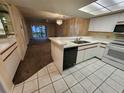 Bright kitchen features white cabinets, appliances, and a breakfast bar overlooking the adjacent living area at 6800 Placida Rd # 1004, Englewood, FL 34224