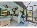 An outdoor kitchen with stainless steel grill, countertop, and appliances at 7108 Harle Ave, North Port, FL 34291