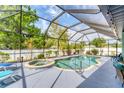 Enclosed pool area with a hot tub and clear blue water at 7108 Harle Ave, North Port, FL 34291