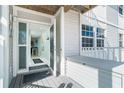 Bright entryway with a glass door, light blue walls, and a view of the dining area at 7466 Palm Island Dr # 2913, Placida, FL 33946