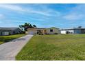 Lovely single-story yellow home with a well-manicured front yard and charming curb appeal at 81 Oakland Hills Pl, Rotonda West, FL 33947