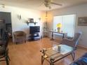 Cozy living area featuring wood floors, neutral tones, and ample natural light at 10275 Euston Ave, Englewood, FL 34224