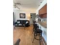 Open concept living space with a breakfast bar and comfortable seating area at 10275 Euston Ave, Englewood, FL 34224