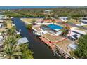 Aerial view showcasing the home's waterfront location with a private boat dock and pool at 1167 Delmar St, Englewood, FL 34224