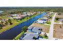 This aerial view showcases a waterfront home with a private pool and expansive green space at 1167 Rotonda Cir, Rotonda West, FL 33947