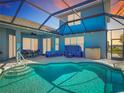 Relaxing screened pool area with cozy seating, dining, and views of the water at 1167 Rotonda Cir, Rotonda West, FL 33947