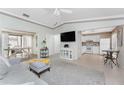 A cozy living room featuring an open layout, contemporary furniture and views into the adjacent kitchen at 13100 S Mccall Rd # 112, Port Charlotte, FL 33981