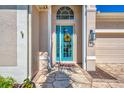 Close up of a beautiful entryway featuring a decorative blue front door with glass panels and a stone pathway at 13335 Golf Pointe Dr, Port Charlotte, FL 33953