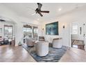 Relaxing living room that has neutral tones, tile flooring, and view to the outdoor pool area at 1953 Georgia Ave, Englewood, FL 34224