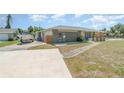 Spacious driveway with a boat parked, leading to a well-maintained, one-story home at 2140 Carnac St, Port Charlotte, FL 33952