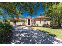 Charming single story home featuring a barrel tile roof and well manicured lawn at 26 Saint Croix Way, Englewood, FL 34223