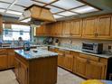 This kitchen offers ample storage, a center island, and tile backsplash, making it perfect for cooking and entertaining at 2650 Colonade Ln, North Port, FL 34286