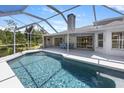 Backyard featuring a screened-in pool and a covered patio with outdoor seating at 270 E Wentworth St, Englewood, FL 34223