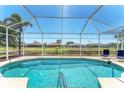 Relaxing screened-in pool area with a stunning waterfront view, perfect for enjoying the Florida sunshine at 39 Fairway Rd, Rotonda West, FL 33947