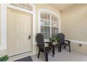 Welcoming front porch features comfortable seating and a view of the home's manicured landscaping at 4 Pine Valley Ln, Rotonda West, FL 33947