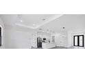 Spacious, bright living room with modern lighting and neutral tones, flowing into the kitchen at 40 Golfview Ct, Rotonda West, FL 33947