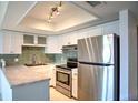 Bright kitchen boasts granite countertops, stainless steel appliances, and white cabinetry at 4410 Warren Ave # 104, Port Charlotte, FL 33953