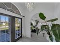 Bright entryway featuring an arched doorway, large plant, and tiled flooring at 56 Long Meadow Ct, Rotonda West, FL 33947