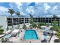 Inviting community pool surrounded by lush landscaping and lounge chairs at beachfront condo buildings at 5700 Gulf Shores Dr # A312, Boca Grande, FL 33921