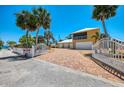 Spacious driveway and gated entrance leading to garages, offering ample parking and privacy at 6029 Manasota Key Rd, Englewood, FL 34223