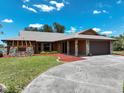 Charming single-story home featuring stone accents, a two-car garage, and well-maintained landscaping at 6305 Shalimar St, Port Charlotte, FL 33981