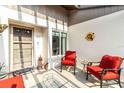Cozy front porch furnished with red chairs and a turtle-themed rug, offering a welcoming outdoor space at 667 Foxwood Blvd, Englewood, FL 34223