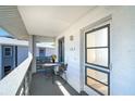 Inviting covered balcony featuring a table and chairs for outdoor seating, creating an inviting space at 6800 Placida Rd # 262, Englewood, FL 34224