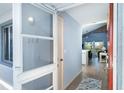 Bright entryway featuring wood-look flooring, a blue accent wall, and views into the open-concept living space at 6800 Placida Rd # 262, Englewood, FL 34224