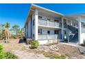 Exterior corner unit with a ground-level patio and second-floor balcony with direct access to the unit at 6800 Placida Rd # 262, Englewood, FL 34224