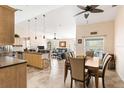 Open-concept living area featuring an island with bar seating, a dining table, and a comfortable living room at 7089 Benson St, Englewood, FL 34224
