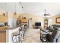 Inviting living space showcasing a kitchen island with seating and a living room with comfortable furnishings at 7089 Benson St, Englewood, FL 34224