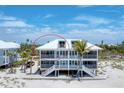 Beachfront home featuring expansive balconies with white railings and steps to the beach at 7554 Palm Island S Dr # 1822, Placida, FL 33946