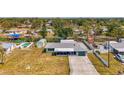 This aerial view of the property showcases the home with a pool, fenced yard, and convenient access to waterfront canals at 842 E 6Th St, Englewood, FL 34223