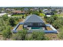 Aerial view showcases the screened-in pool and fenced yard at 9283 Newnan Cir, Port Charlotte, FL 33981