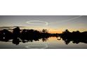 Enjoy the sunset reflecting over the water in this quiet waterfront community at 9404 Arnaz Cir, Port Charlotte, FL 33981