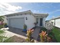 Charming home exterior with well-manicured landscaping and inviting walkway at 9853 Bright Water Dr, Englewood, FL 34223