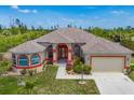 Charming one-story home boasts beautiful landscaping, a long driveway, and an attached two-car garage at 10495 Atenia St, Port Charlotte, FL 33981