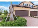 Charming home exterior with a well-maintained driveway, lush greenery, and a two-car garage at 10805 Tarflower Dr # 101, Venice, FL 34293
