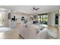 Bright living room with large windows and modern kitchen view, perfect for entertaining at 10805 Tarflower Dr # 101, Venice, FL 34293