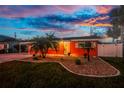 Charming single-story home featuring a neatly landscaped front yard with palm trees and a well-maintained lawn at 1245 Gulf Blvd, Englewood, FL 34223